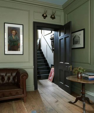 Light green living room with black door