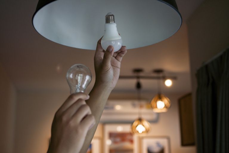 a person changing a light bulb