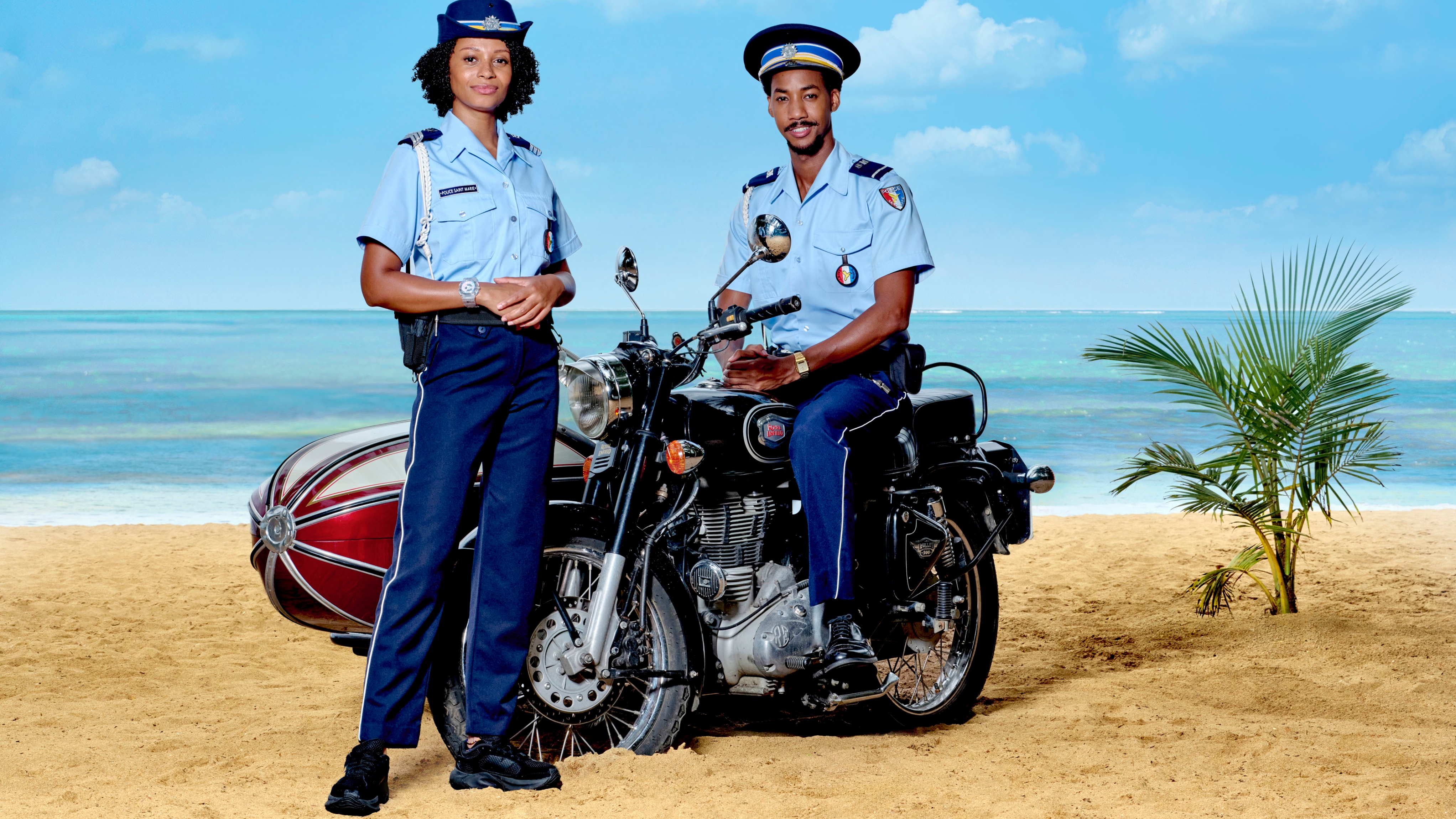 (L-R) Sergeant Mattie Fletcher (CATHERINE GARTON), Sebastian Rose (SHAQUILLE ALI-YEBUAH) in Death in Paradise season 15