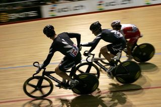 New Zealand's Marc Ryan and Thomas Scully exchange during the madison