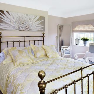 guest bedroom with metal bed and white chair