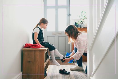 a young girl putting on her school shoes and getting ready to go back to school with her mum
