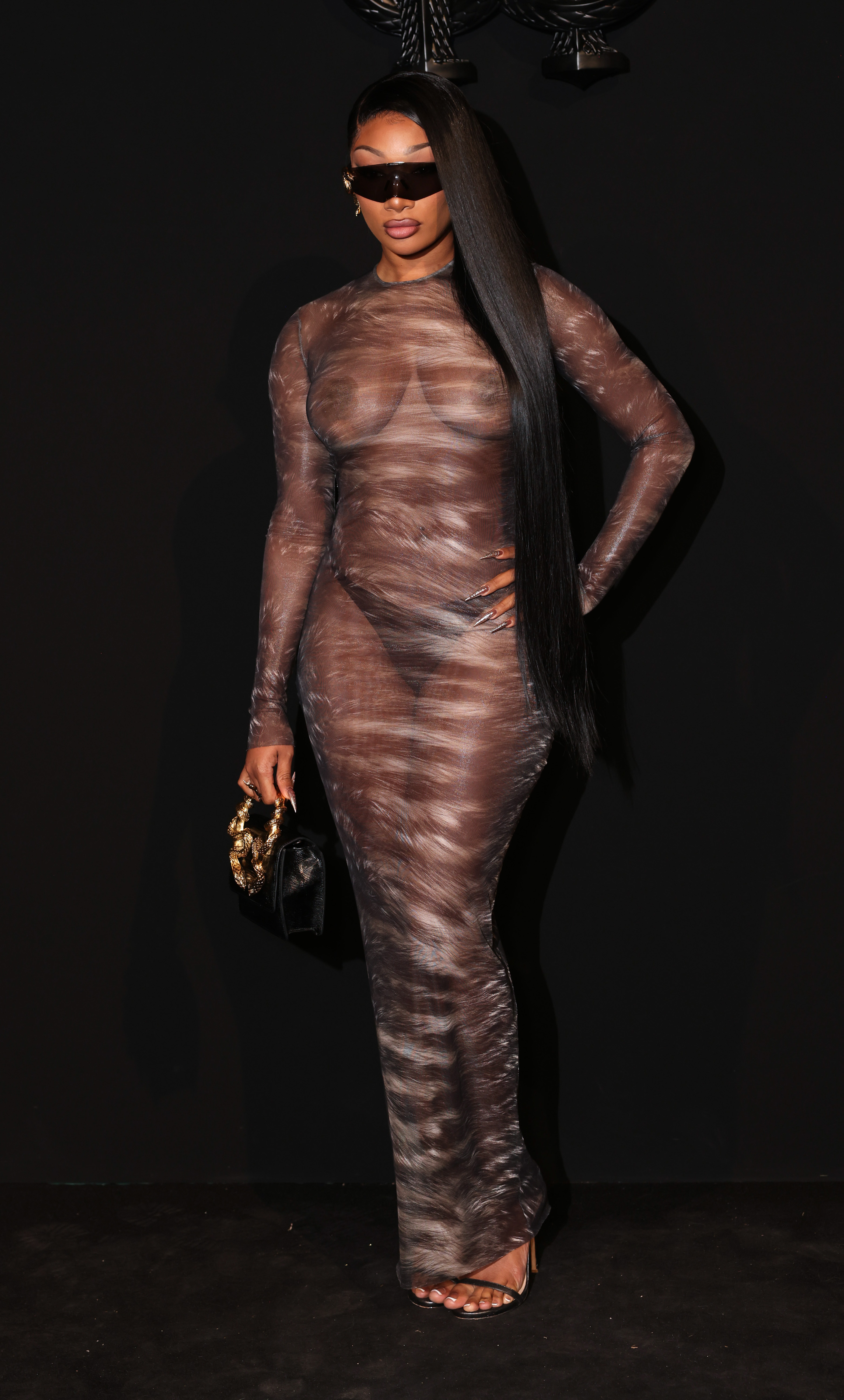 Megan Thee Stallion arrived at the Roberto Cavalli Milan Fashion Week show in a thong-revealing naked dress