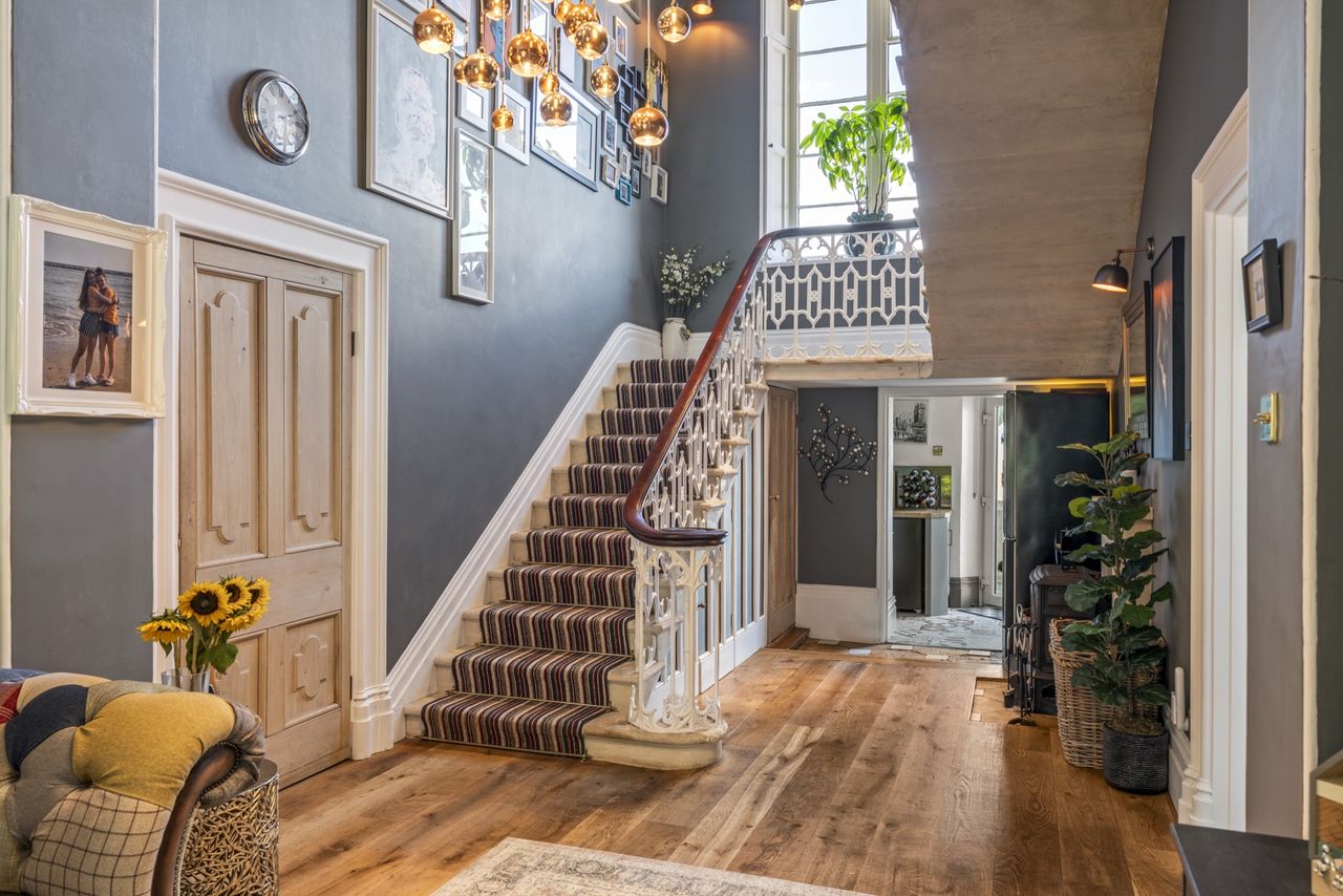 Detail of the interiors of Woodside, featuring lots of soft blues, funky artwork, wooden floors, and natural light