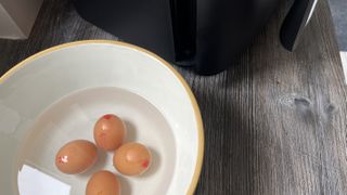 air fried eggs in a bowl of water to prevent further cooking
