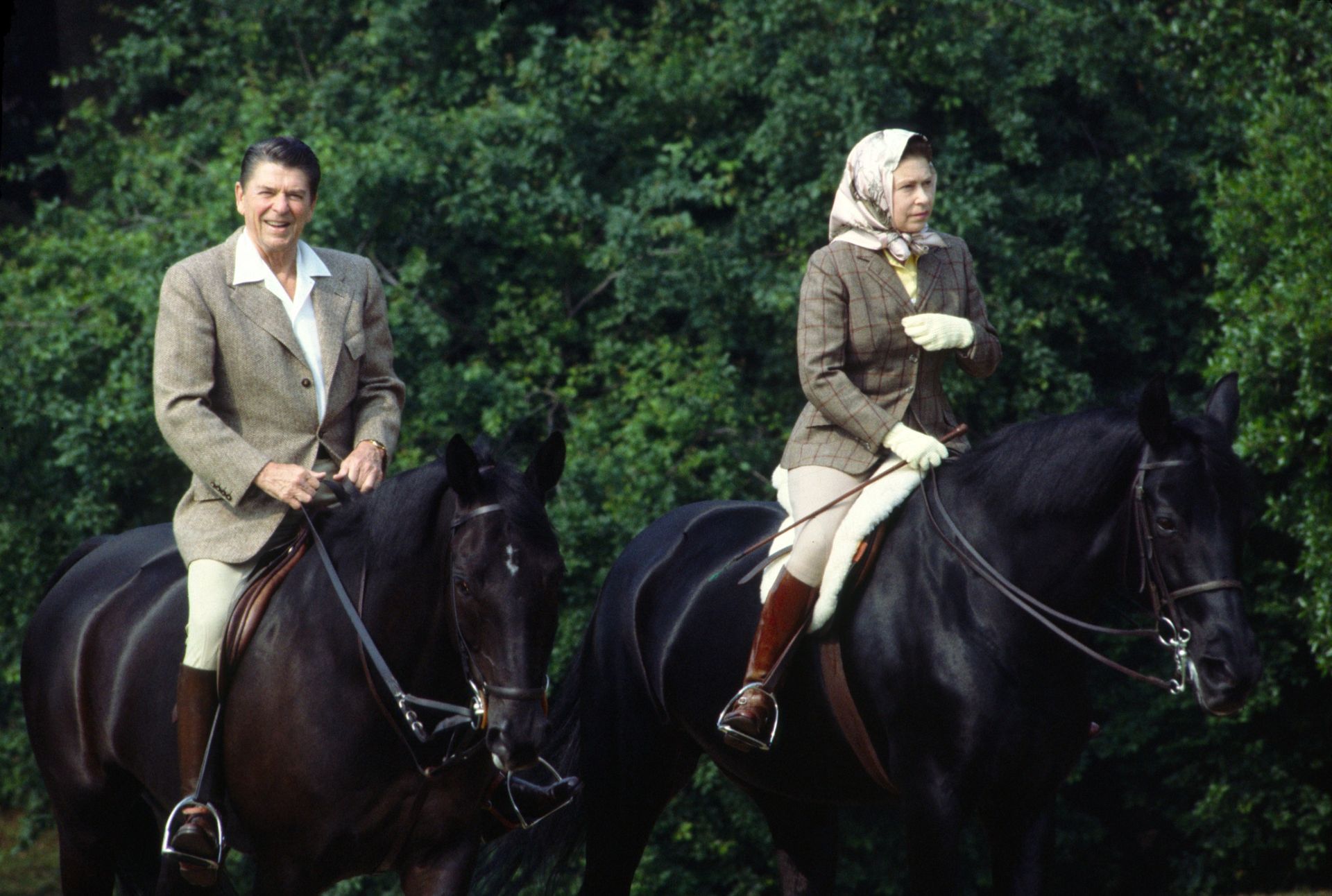 Queen Elizabeth riding horses with Ronald Reagan