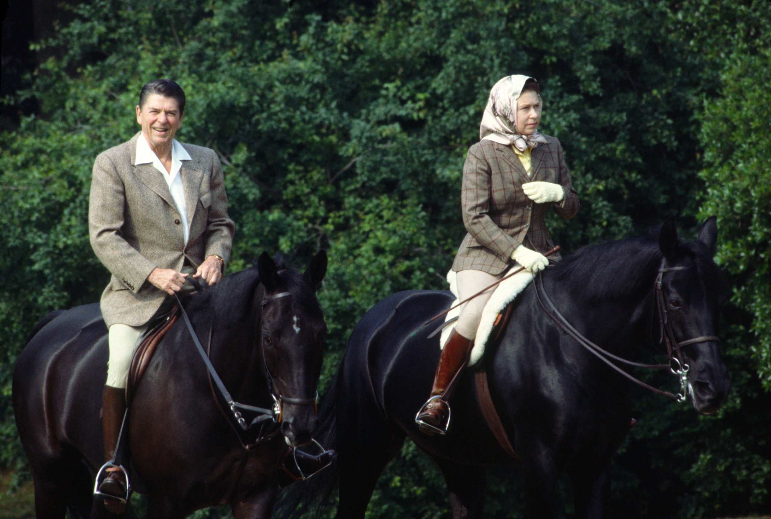 Queen Elizabeth riding horses with Ronald Reagan