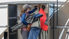 Rider packing lorry with horse travel kit in tack locker