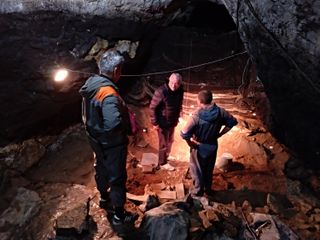 Researchers Michael Shunkov, Maxim Kozlikin and Vladimir Uliyanov convene in the south chamber of Denisova Cave.