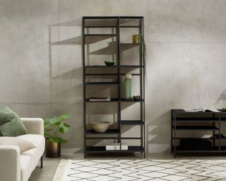 Munro Shelving Unit against grey concrete wall and decorated with books, vases and plants
