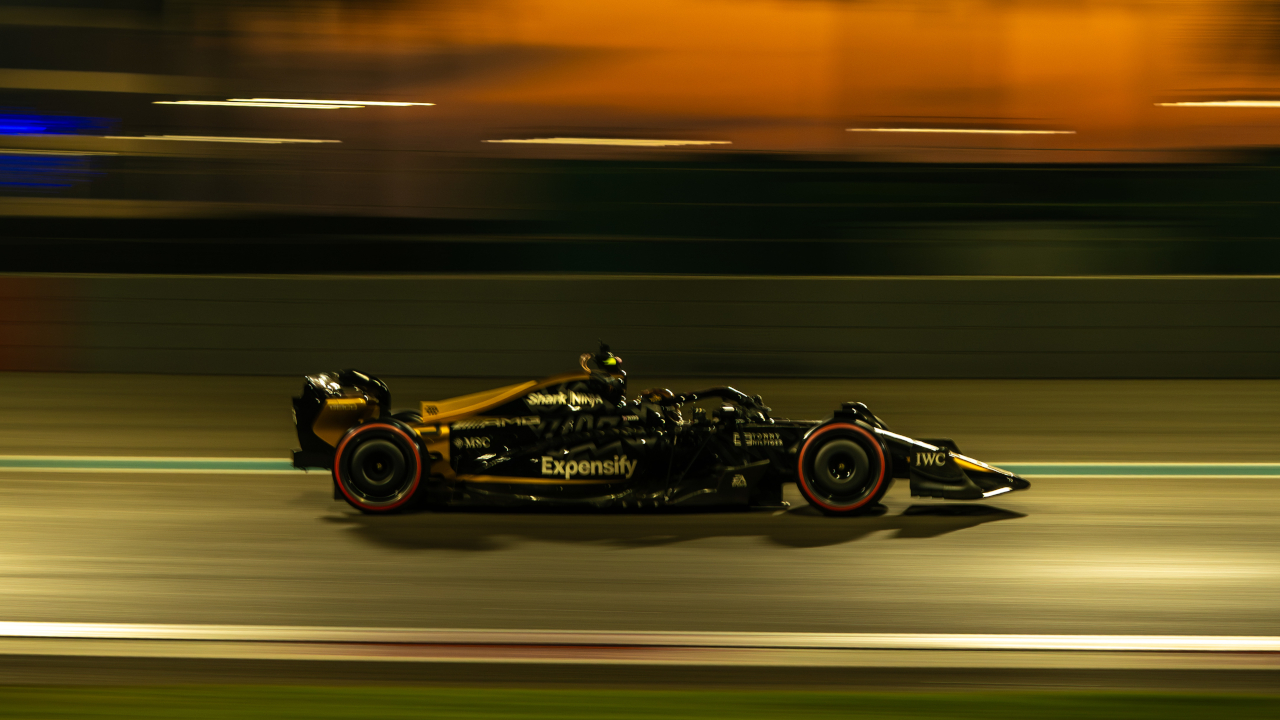 An F1 car streaks across the track in F1.