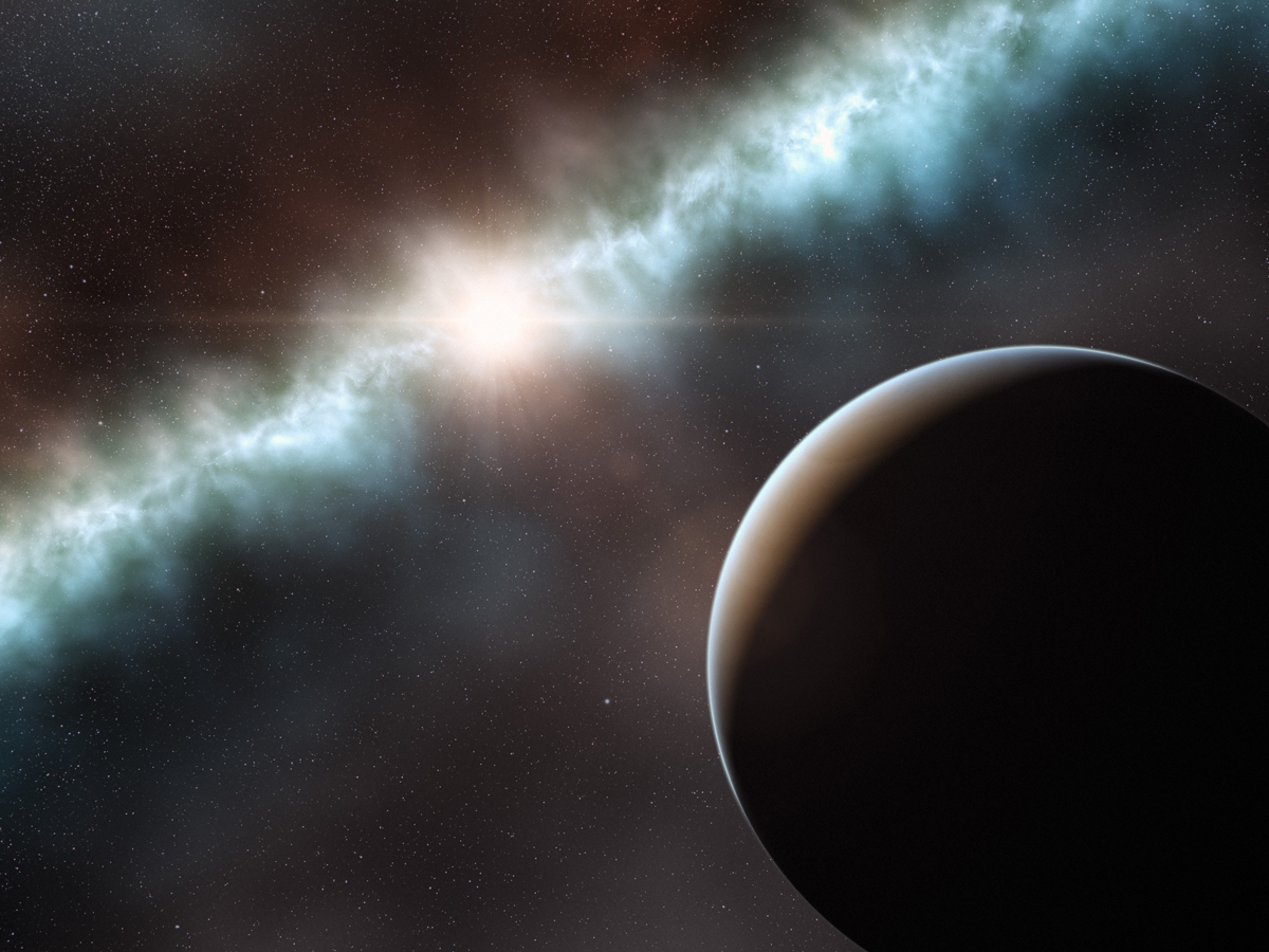 Artist&#039;s concept of a possible alien planet and the dust disk around the star T Cha