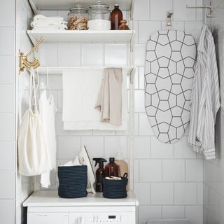 utility room with white wall with golden hooks