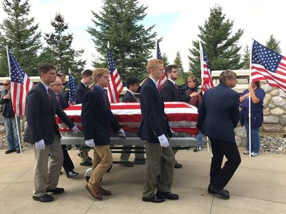 Pallbearers from the University of Detroit Jesuit High School and Academy.
