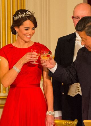 Kate Middleton at a State Banquet wearing a diamond bracelet and red dress