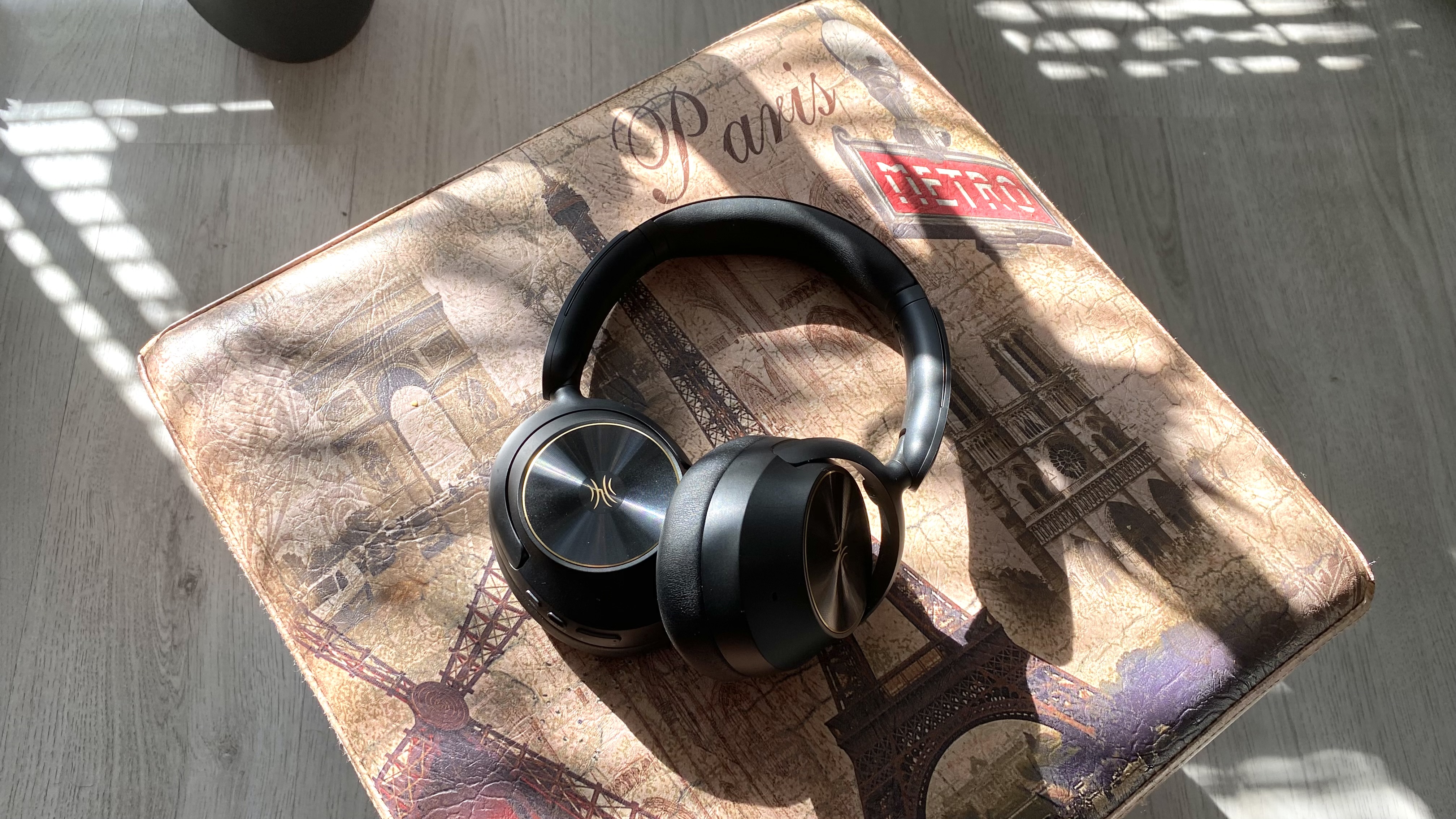 OneOdio Focus A6 over-ear headphones on a Parisian stool