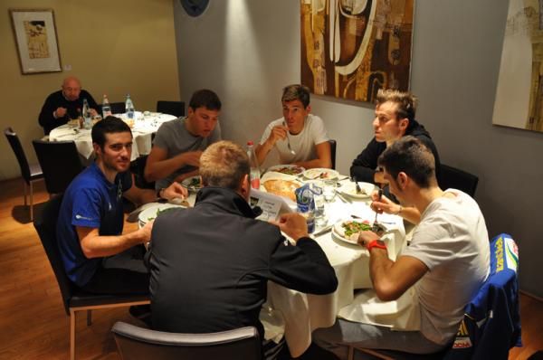 The team enjoying dinner at their Italian camp