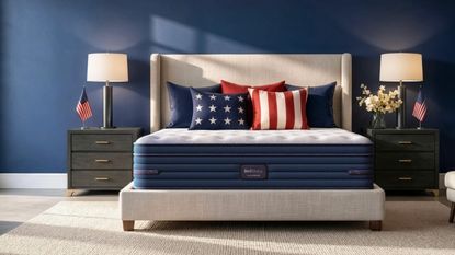 BedStory mattress on a grey bed in blue bedroom with matching black nightstands to either side with white lampshades.