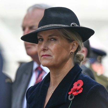 Duchess Sophie wearing a navy hat and coat with a poppy brooch