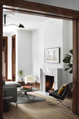 white living room with ridged fireplace and mid century furniture