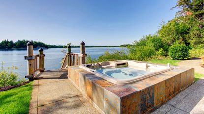 An example of the rules for buying a hot tub, a hot tub on a deck overlooking a lake