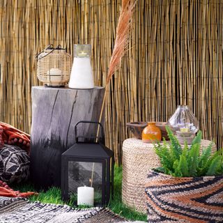 garden area with bamboo screen and candle lantern