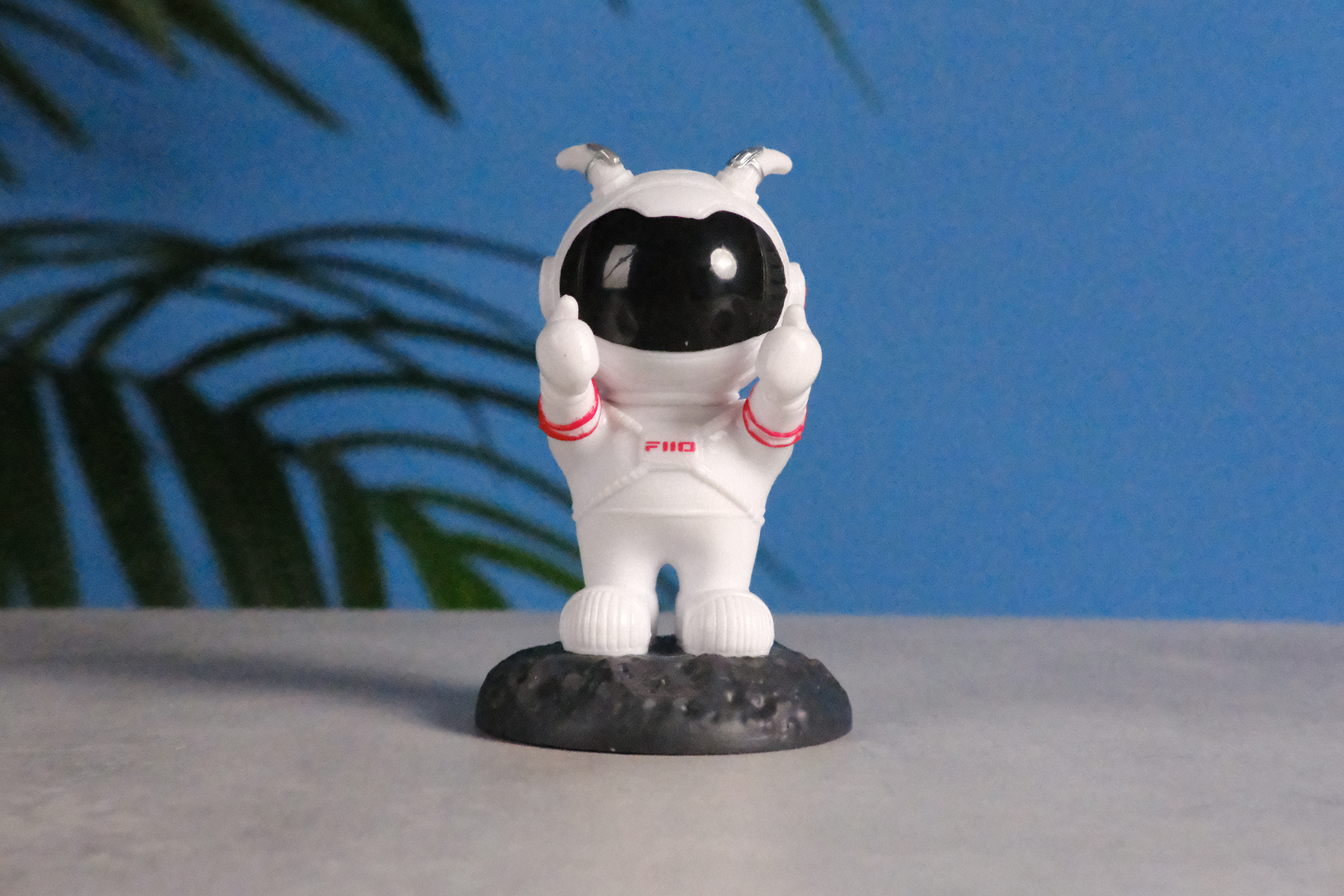 A photo of an astronaut toy against a blue background, taken on the Fujifilm X-E5