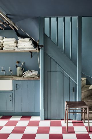 laundry room storage ideas blue room with open shelving and patterned floor tiles by Little Greene