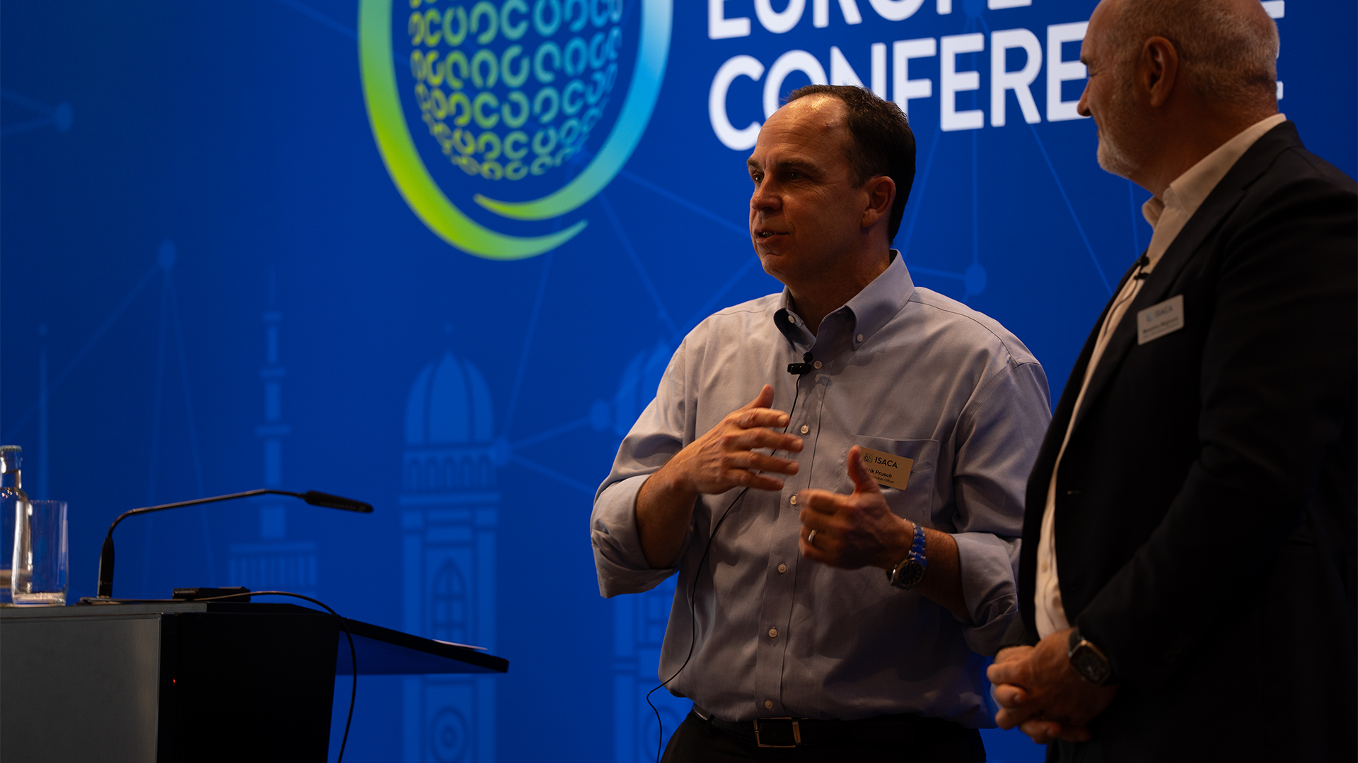 ISACA CEO Erik Prusch pictured on stage during the opening keynote at the ISACA 2026 Europe Conference in Munich, Germany.