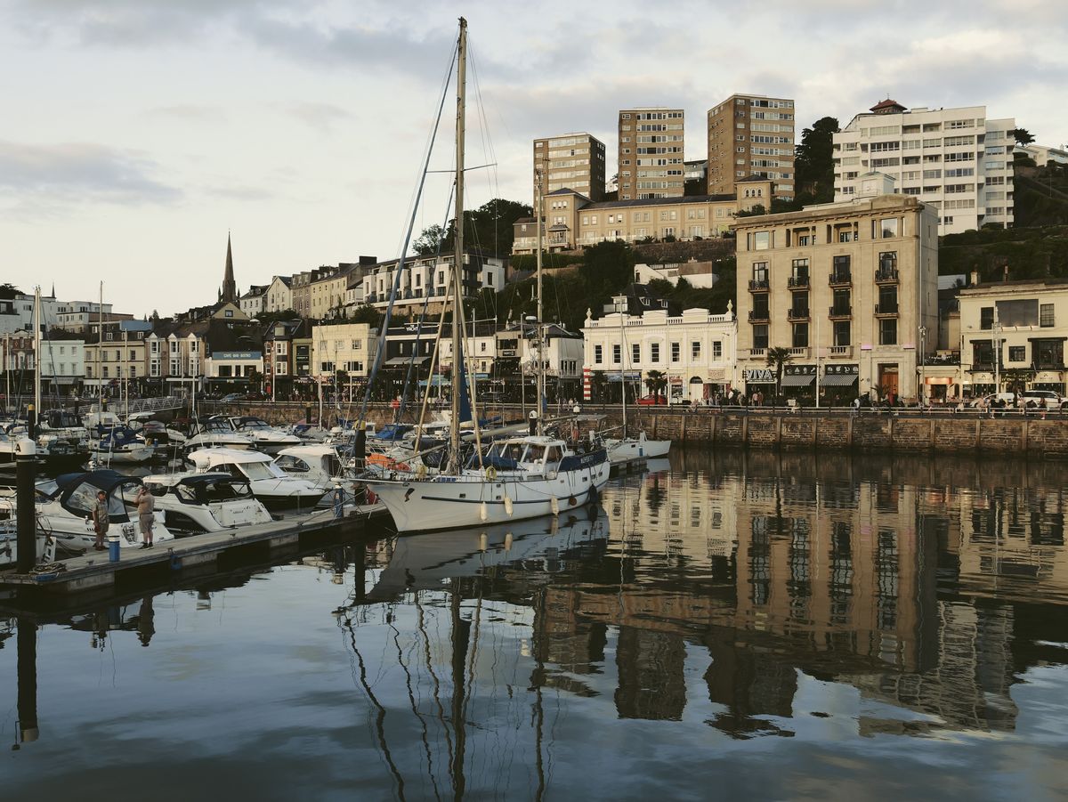 Sample image taken with the Panasonic Lumix L10; a sail boat in a harbour, the water is still, it's golden hour