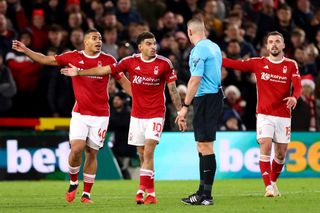 Murillo, Morgan Gibbs-White and Harry Toffolo of Nottingham Forest react towards Match Referee Robert Jones during the Premier League match between Nottingham Forest and AFC Bournemouth at City Ground on December 23, 2023 in Nottingham, England