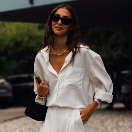 woman wearing white button down shirt and white pants 