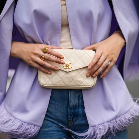 woman with lilac jacket, chanel bag and floral nails for spring
