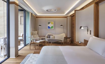 Bedroom in neutral tones with teak highlights