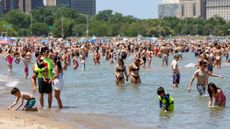 Beachgoers are seen cooling off in Chicago's Lake Michigan on June 21, 2025.