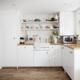 white kitchen with cabinets and worktop