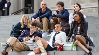 The cast of HBO Max's Gossip Girl reboot sitting on the steps of the Metropolitan Museum of Art