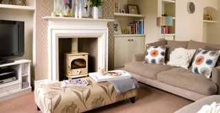 neutral living room with a log burner and sofa facing into the room to show living room design mistakes to avoid