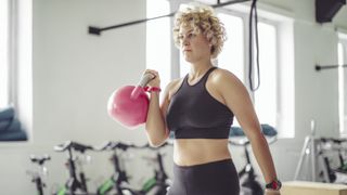 Woman lifting kettlebell in functional training workout