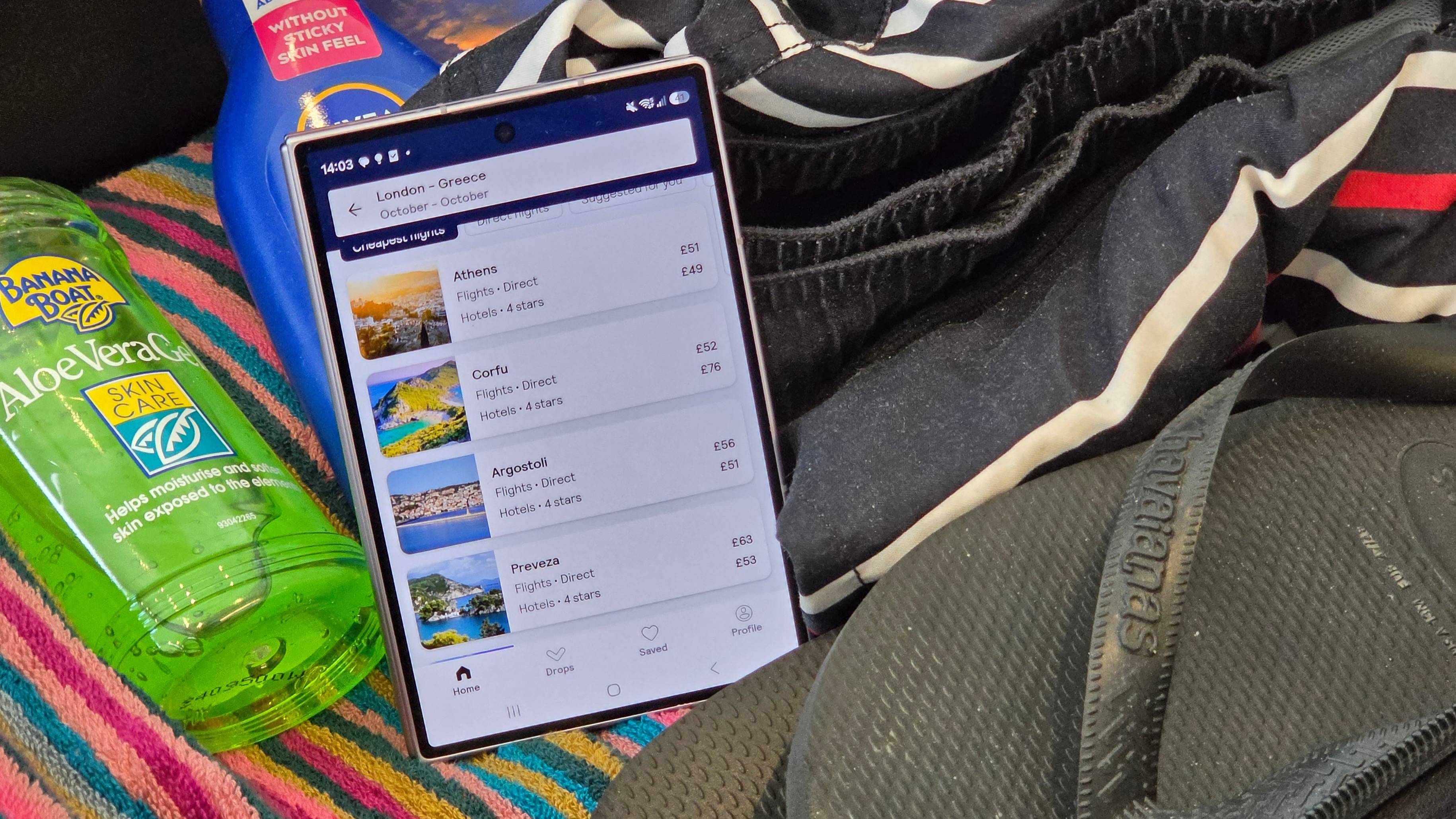 The Samsung Galaxy Z Fold 8, showing the Skyscanner app, in a suitcase.