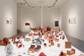 Installation view of Chiharu Shiota, 'Living Inside' at Galerie Templon, Brussels, a doll's house like installation of sculpture. Photography: Isabelle Arthuis