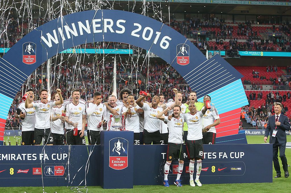 The Manchester United squad celebrate with the FA Cup trophy after The Emirates FA Cup final match between Manchester United and Crystal Palace at Wembley Stadium on May 21, 2016 in London, England. (Photo by Tom Purslow/Manchester United via Getty Images)