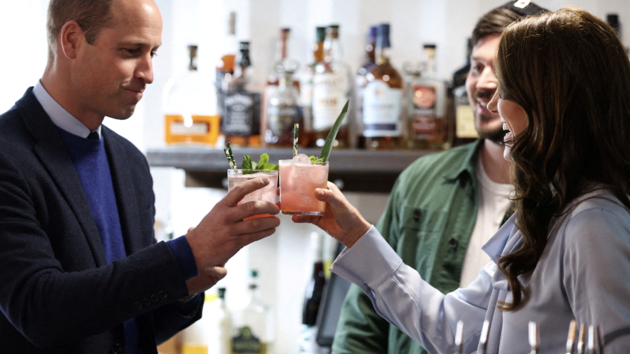 Britain&#039;s Catherine, Princess of Wales (R) and Britain&#039;s Prince William, Prince of Wales drink a cocktail as they visit the Trademarket outdoor market in Belfast, Northern Ireland, on October 6, 2022.