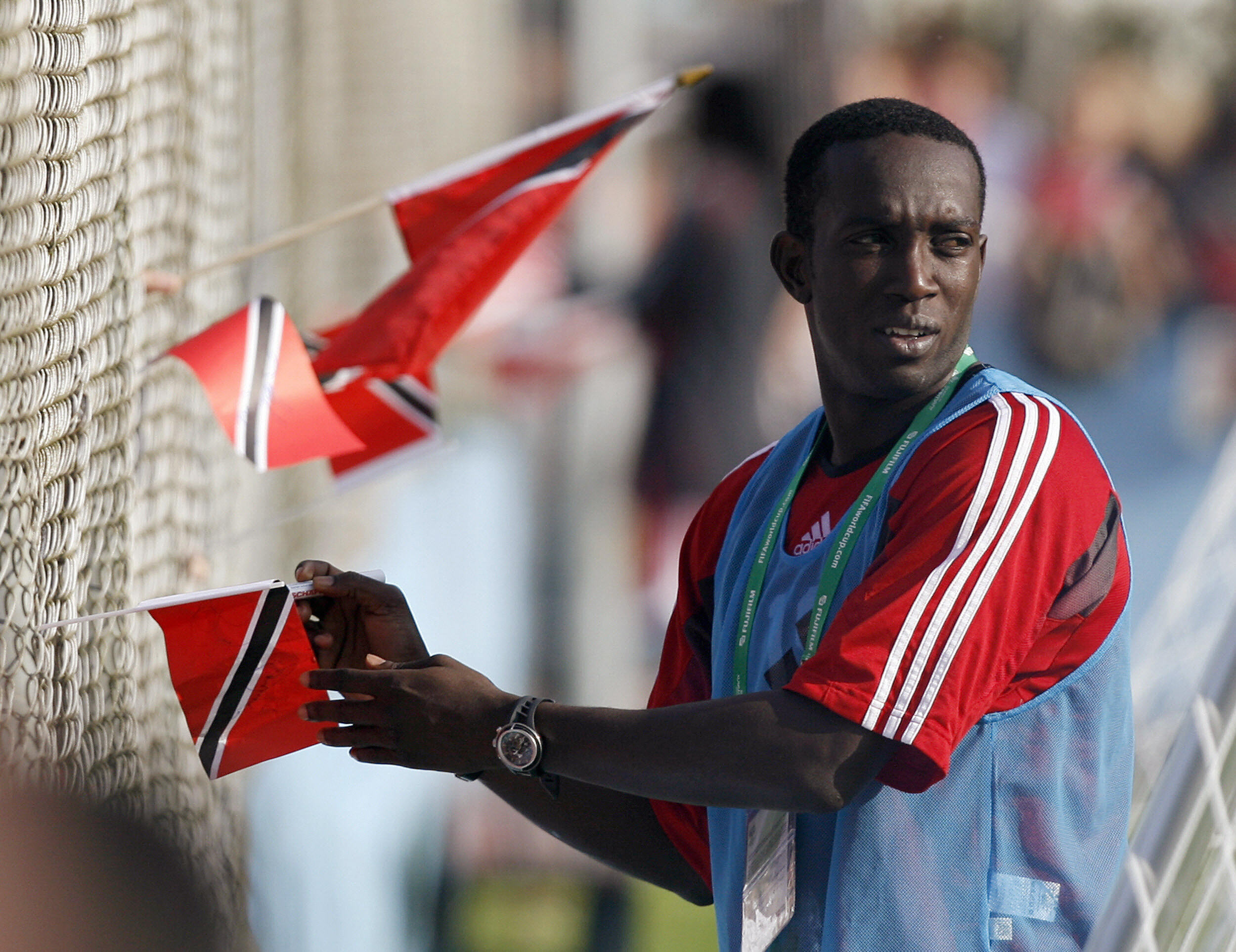 Trinidad and Tobago forward Dwight Yorke signs autographs for fans during a training session at the 2006 World Cup in Germany.