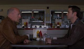 Looper Bruce Willis and Joseph Gordon-Levitt talking at the diner