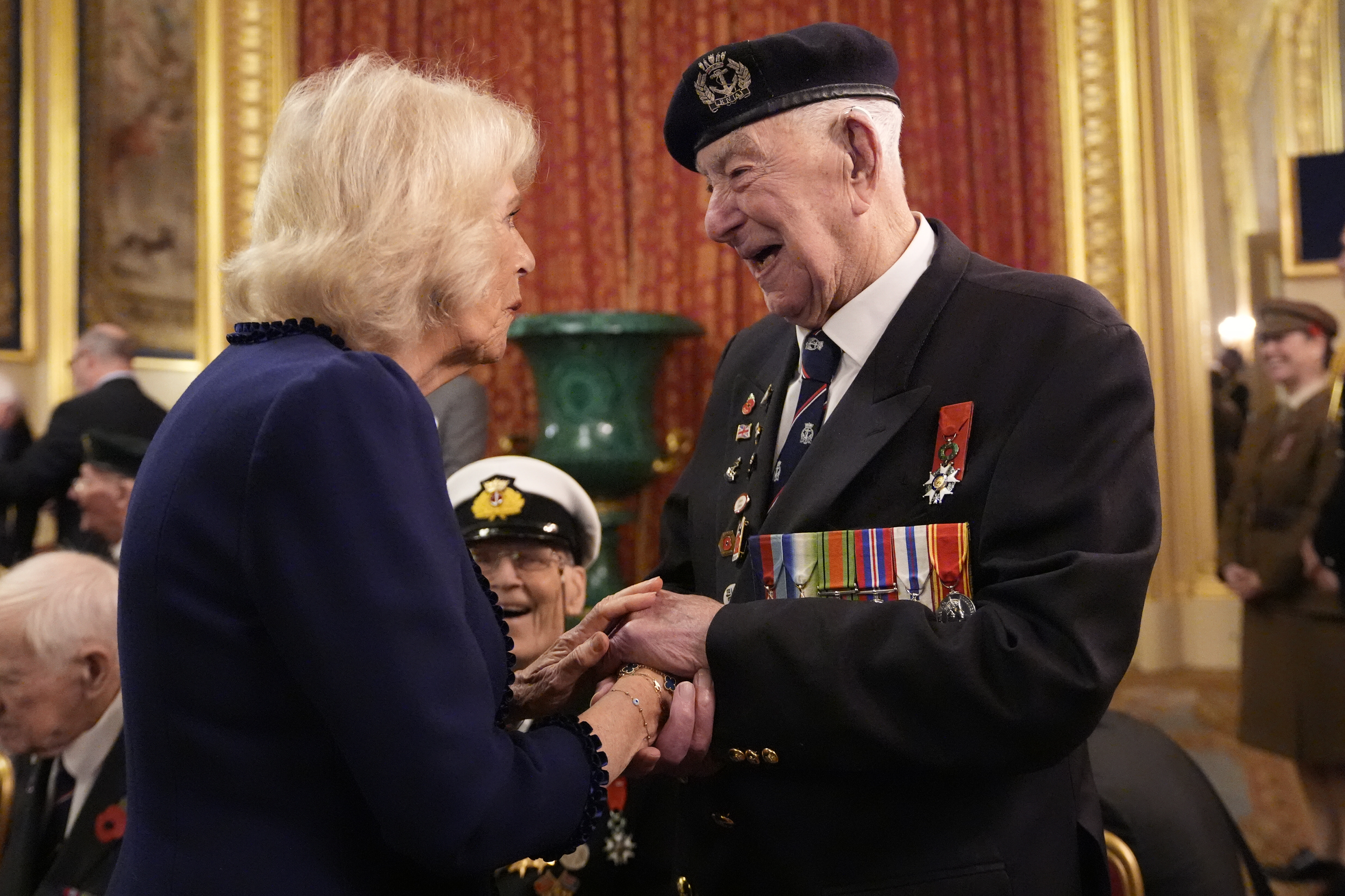 Queen Camilla holding hands with a veteran