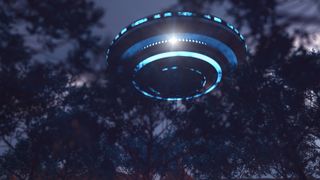 a flying saucer ringed by lights is barely visible through dense trees