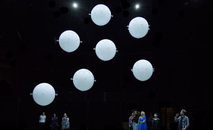 White spheres with people looking up at them
