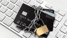 Debanked: Padlocked banks cards on keyboard