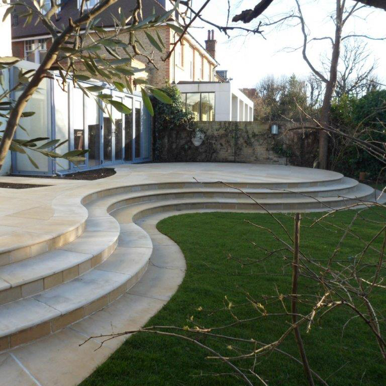 curved garden steps leading down to a patio